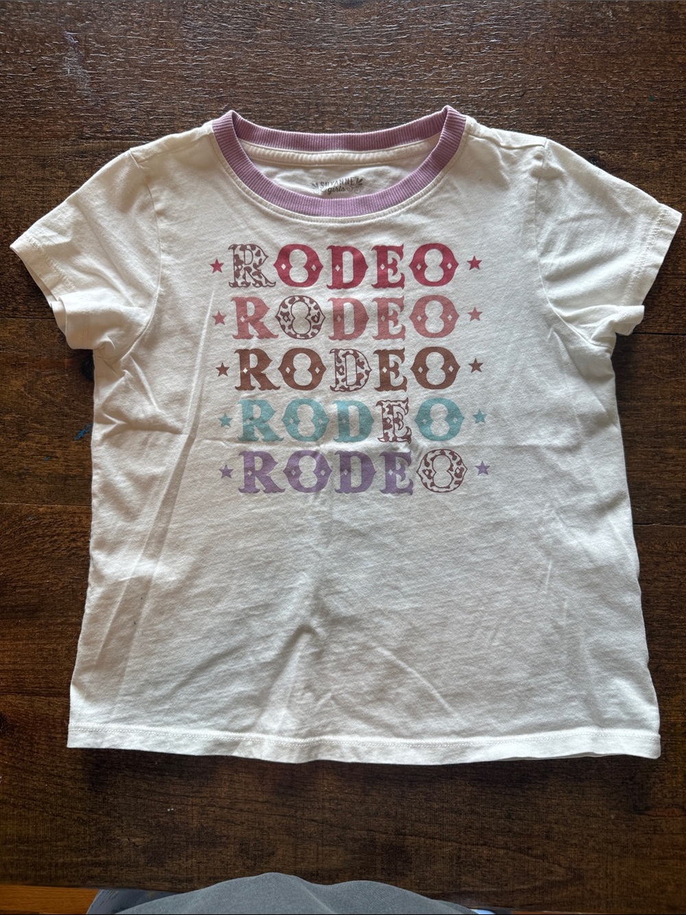 Shyanne White Tee with Pastel Rodeo Graphic and Lilac Neck trim